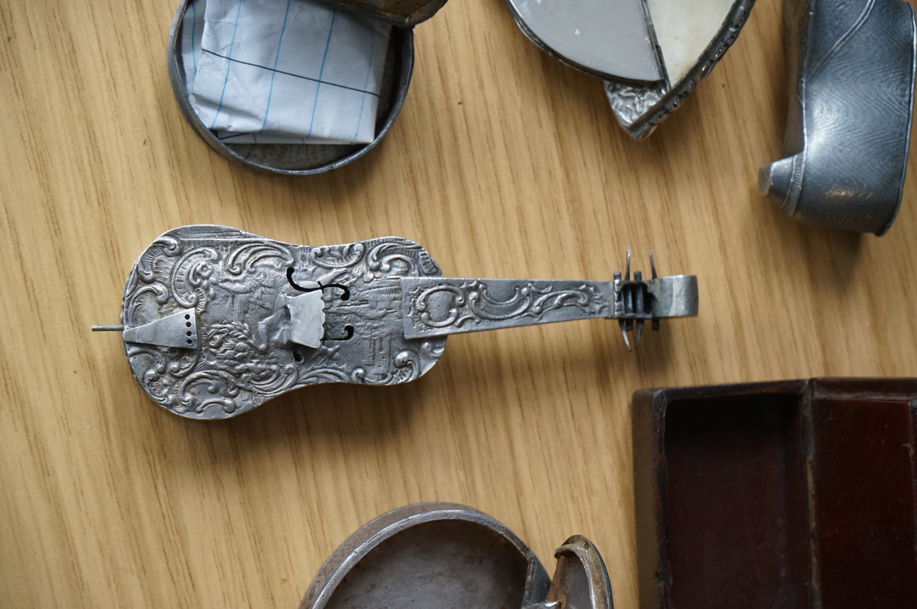 A collection of mixed metal stuff boxes including a novelty cello shaped box being 12cm long
